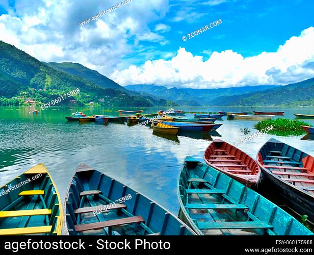 Gorgeous view of colourful boats on calm Fewa lake, Pokhara, Nepal. High quality photo