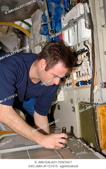 NASA astronaut Greg Chamitoff, Expedition 17 flight engineer, performs in-flight maintenance on the Treadmill Vibration Isolation System (TVIS) in the Zvezda...