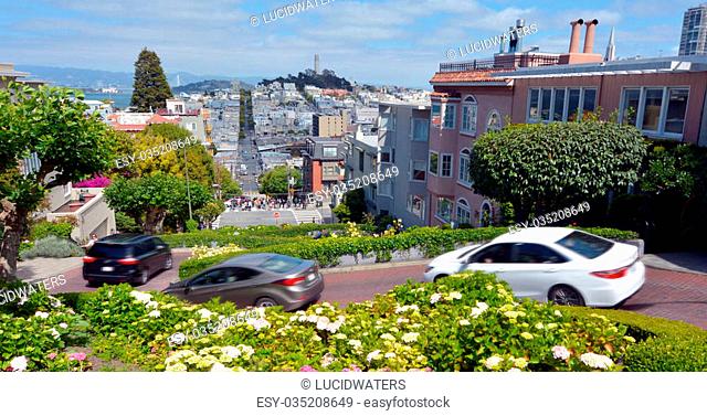 SAN FRANCISCO - MAY 20 2015:Panoramic view of Lombard Street switchback against San Francisco skyline.Lombard Street is known for it's 8 sharp turns make it the...