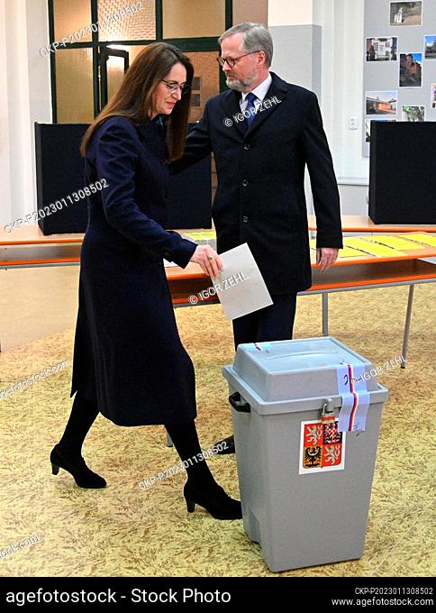 Prime Minister Petr Fiala (ODS), accompanied by his wife Jana, casts his vote in the first round of presidential election in Brno, Czech Republic, January 13