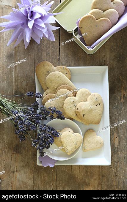Heart-shaped, gluten-free lavender shortbread biscuits on a serving platter and in a biscuit tin