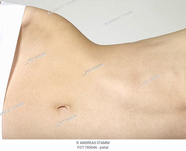Midsection of a woman lying on her side