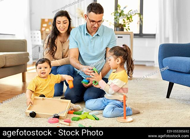 happy family palying with wooden toys at home