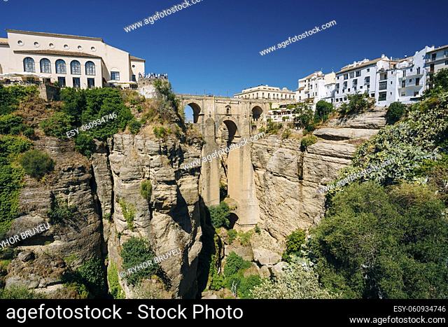 The New Bridge or Puente Nuevo Is The 120-metre-deep Chasm That Carries The Guadalevin River And Divides City Of Ronda, Province Of Malaga, Spain