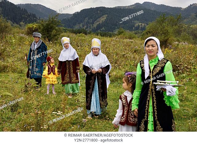 Kazakh family in field after Tusau Kesu ceremony at Huns Village near Almaty Kazakhstan