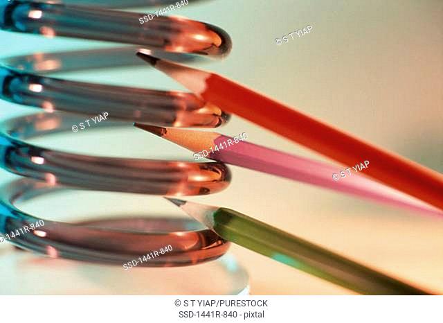 Pencils between spring coils