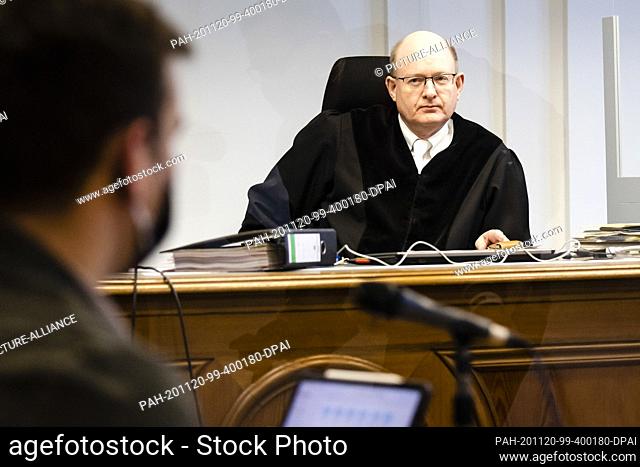 20 November 2020, Schleswig-Holstein, Kiel: The presiding judge Stephan Worpenberg (r) looks at the accused. The man is accused of having abused two female...