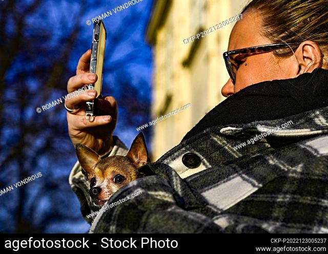 A woman with dog takes selfie during the sunny weather in Prague, Czech Republic, December 30, 2022. (CTK Photo/Roman Vondrous)