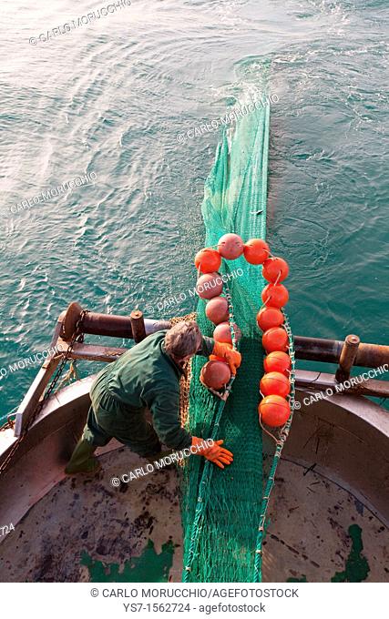 Fishermen at work on a trawler in the north Adriatic sea, Chioggia, Venice province, Italy