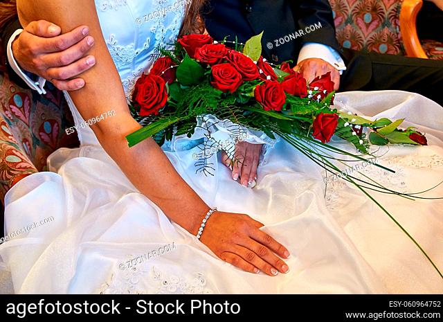 bride holding wedding bouquet and groom
