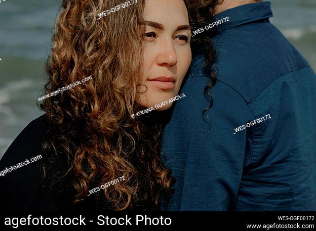 Portrait of woman leaning on her husband's shoulder