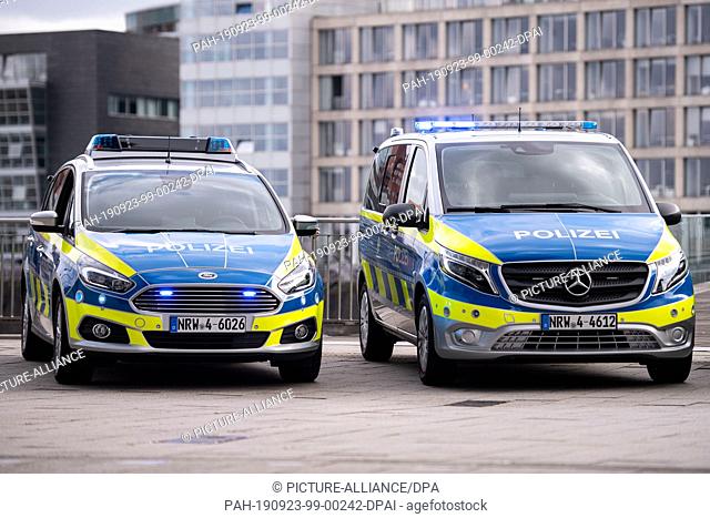 23 September 2019, North Rhine-Westphalia, Duesseldorf: New Mercedes Benz Vito (r) and Ford S-Max police cars are parked in the Media Harbour