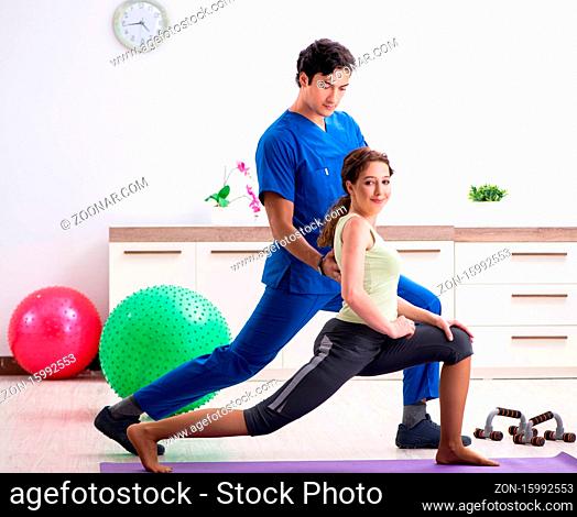 The fitness instructor helping sportsman during exercise