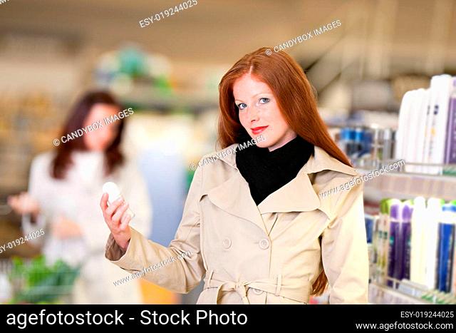 Shopping - young woman choose deodorant