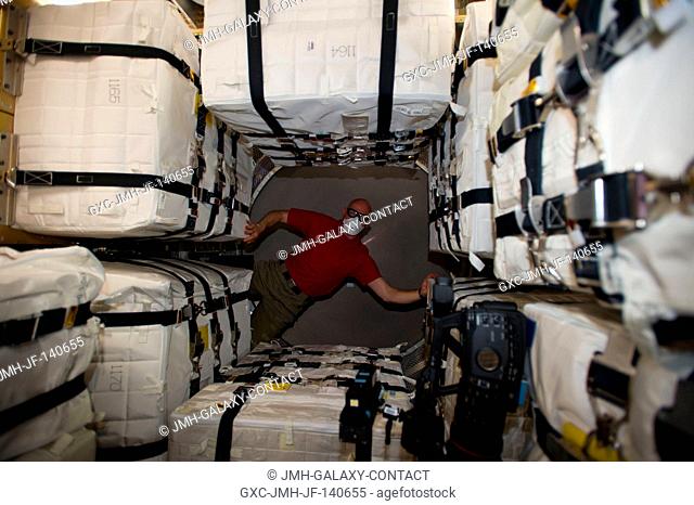 Surrounded by stowage containers, European Space Agency astronaut Alexander Gerst, Expedition 40 flight engineer, is pictured in the newly-attached Georges...