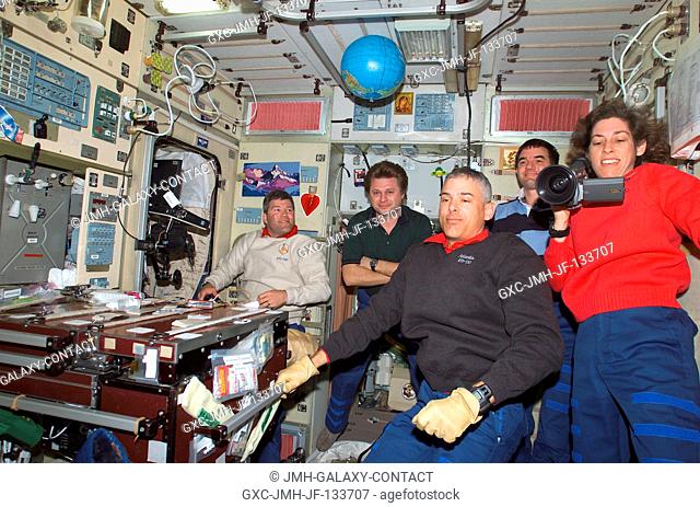 Astronauts Lee M. E. Morin (left foreground) and Ellen Ochoa, both STS-110 mission specialists; along with astronaut Stephen N