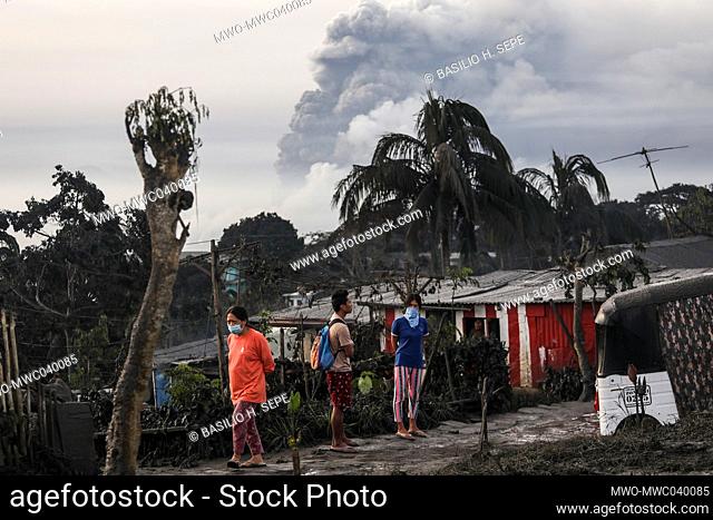Residents watch as the Taal volcano erupts in Tagaytay, Cavite province south of Manila. Taal Volcano is a large caldera filled by Taal Lake in the Philippines
