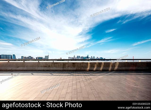 empty marble floor and cityscape of hangzhou qianjiang new city in blue cloud sky