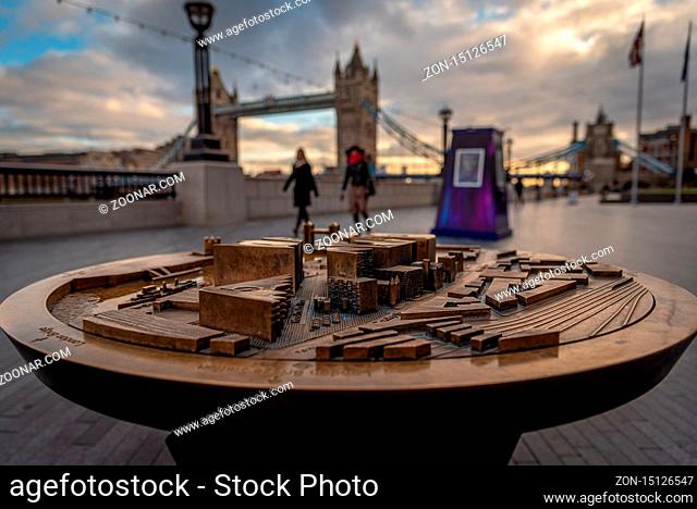 LONDON, ENGLAND, DECEMBER 10th, 2018: Tower Bridge in London, United Kingdom at sunrise with beautiful clouds and model of nearby tourist area