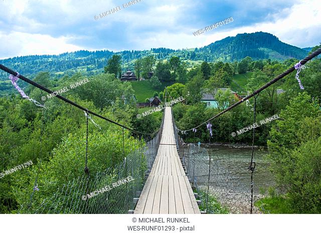 Ukraine, Carpathian mountains, Swinging bridge in Yasinia village