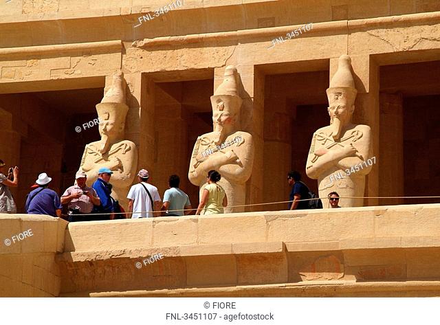 Tourists in front of statues at the Hatschepsut Temple, Luxor, Egypt, low angle view