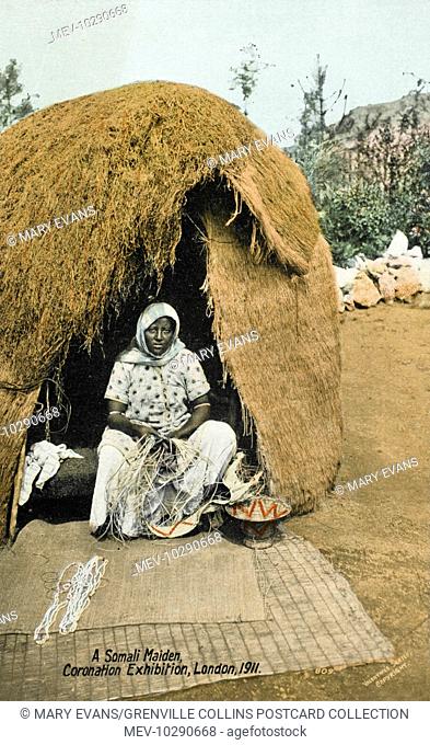 A Somali Woman weaving in the entrance to her reed hut - an 'exhibit' at the Coronation Exhibition of 1911 in London