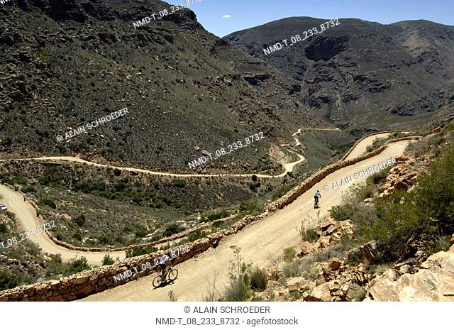 High angle view of two cyclists mountain biking, The Swartenberg Pass, Western Cape Province, South Africa