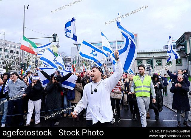 19 November 2023, Berlin: Demonstrators sing pro-Jewish songs and wave Israeli flags at the ""Jewish Life Berlin"" demonstration for Israel and against...