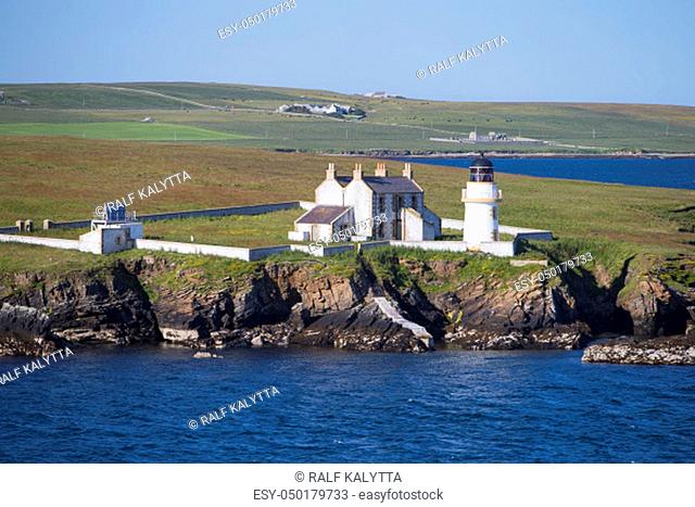 The photo shows a panoramic view of a lighthouse on the Orkney Islands