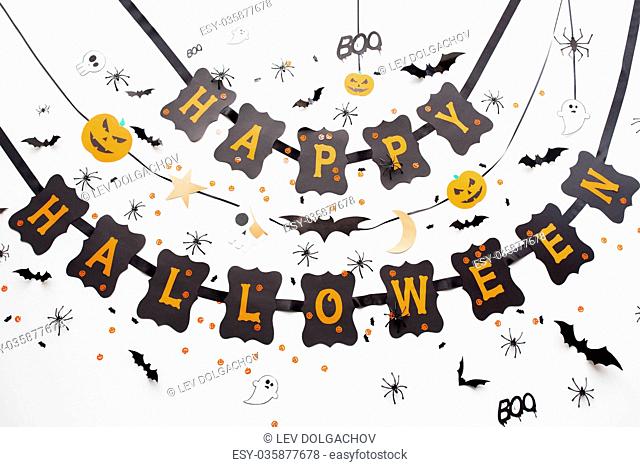 holidays, decoration and party concept - happy halloween festive paper black garland or banner with bats and spiders over white background
