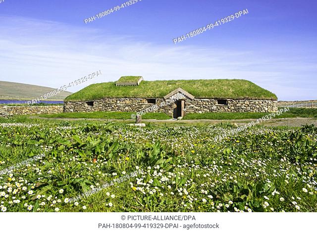 10 June 2018, United Kingdom, Unst: A replica of a Norse Viking longhouse stands at Brookpoint on the Scottish Shetland Islands