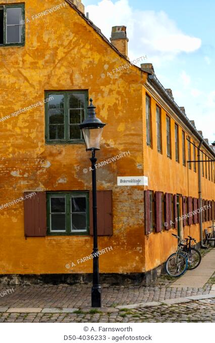 Copenhagen, Denmark Bicyclists pass row houses in the historic Nyboder district