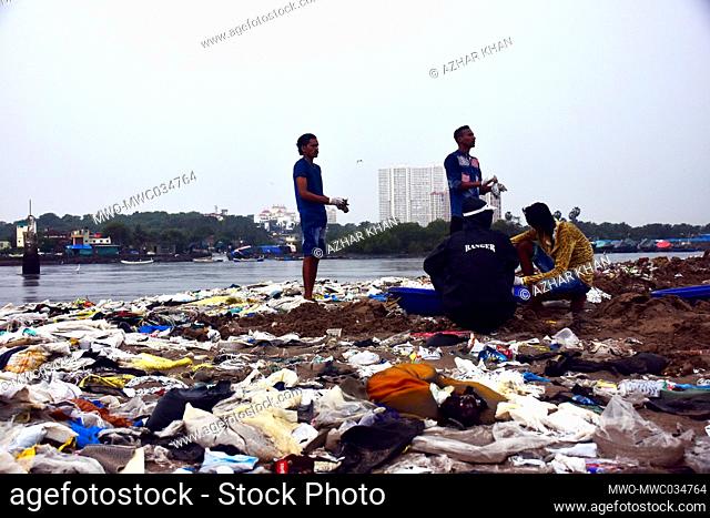 Volunteer’s pick-up trash during a beach clean-up program at Versova beach in Mumbai. Afroz Shah started cleaning work to remove tons of solid waste from the...