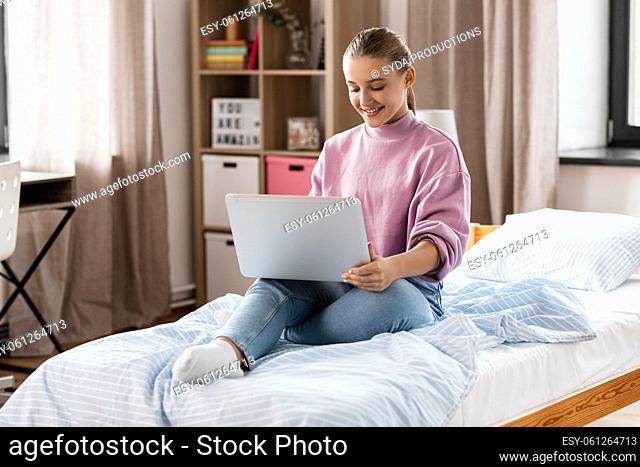 student girl with laptop computer learning at home
