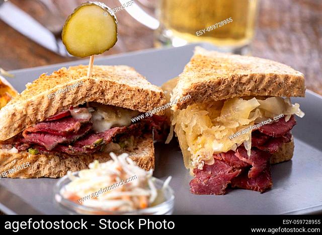 reuben sandwich on a plate with fries