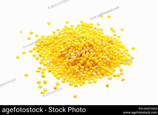 Heap of millet groats isolated on white background with clipping path. Close-up, top view