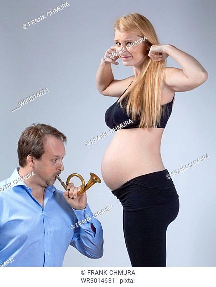 Pregnant Woman with her Partner Playing Music for the Baby
