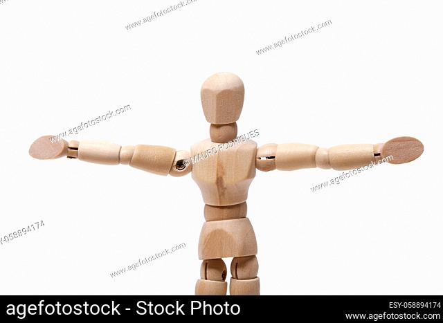 Close up view of a wooden dummy with arms wide open isolated on a white background