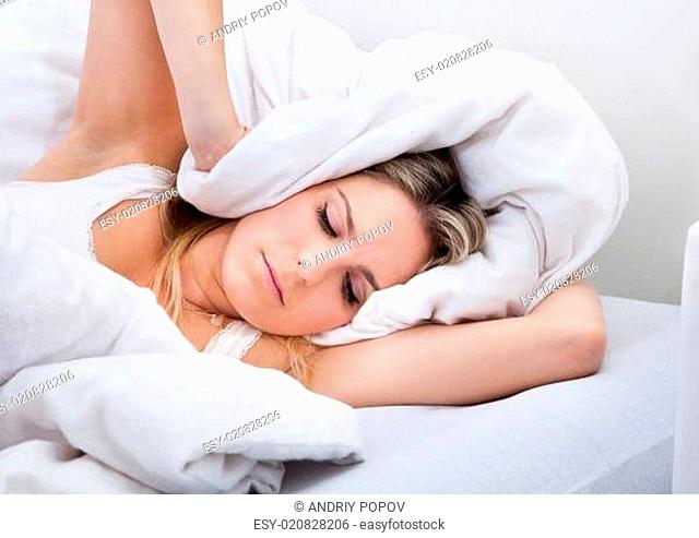 Woman with a bedsheet over her head