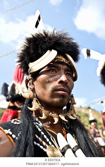 Naga tribesman in traditional outfit during the annual Hornbill Festival at Kisama, Kohima, Nagaland, India