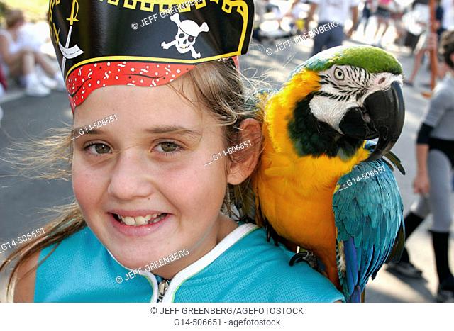 Annual satire parade, parody, girl, pirate, hat, parrot, shoulder. King Mango Strut. Coconut Grove. Florida. USA