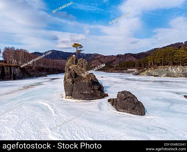Fast mountain river Katun in Altay, Siberia, Russia. A popular tourist place called the Dragon's Teeth. Beauty sunny winter day
