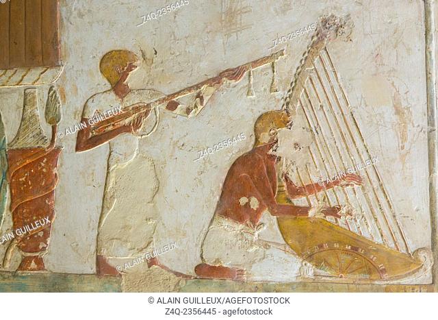 UNESCO World Heritage, Thebes in Egypt, Valley of the Nobles, tomb of Benia. Musicians playing lute and harp. The harp is movable thanks to its wheels