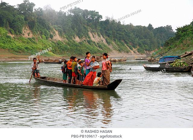 Ethnic children going to school by boat through the Sangu River Thanchi, Bandarban, Bangladesh November 2010