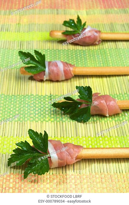 Grissini with raw ham and parsley