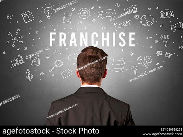 Rear view of a businessman with FRANCHISE inscription, modern business concept