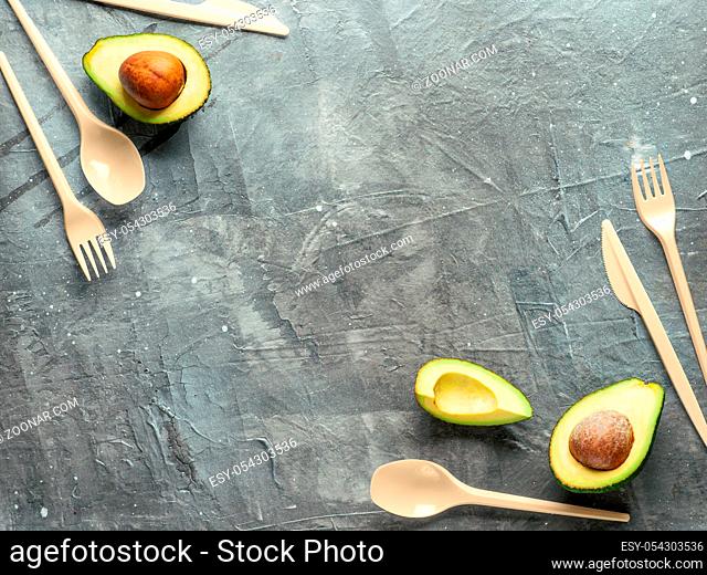 Avocado Seeds Biodegradable Single-Use Cutlery. Bioplastic - Great alternative to plastic disposable cutlery. Top view, flat lay. Gray background