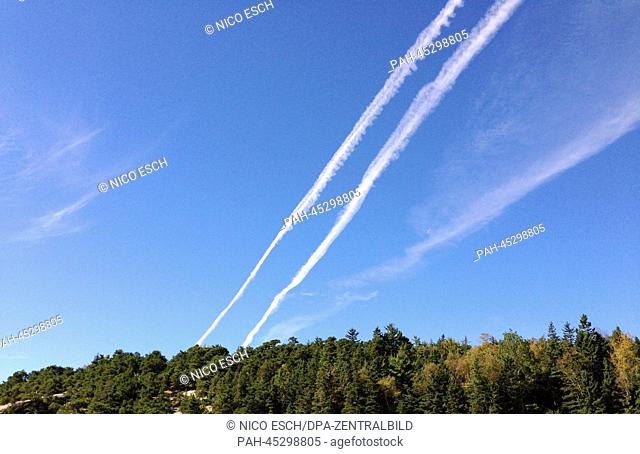 Jet trails are pictured at the blue sky above the 'Sand Beach' in the Acadia National Park in Maine, USA, 27 September 2013