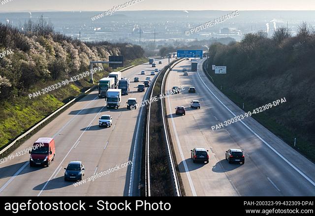 23 March 2020, Saxony, Dresden: Cars drive in the morning on the A4 motorway. To contain the coronavirus, Saxony now bans all accumulations of three or more...