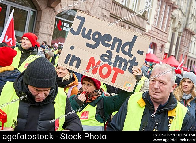 22 November 2023, Hamburg: A participant in the opening rally at the trade union building at Besenbinderhof holds a banner with the inscription ""Jugendamt in...